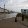 Water and sand run where once a street ran.