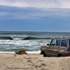 a woody overlooks a peeling A-frame wave in The Outer Banks