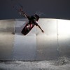 a kiteboarder does a trick on a wallride obstical in cape hatteras nc