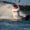 a kiteboarder edges in the water and prepares to do a trick