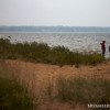 Two kiteboarder look out at the lake