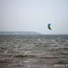 A kiteboarder riding on Muskegon Lake