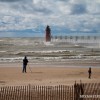 onlookers whatch as watermen headout into the rough waters off south haven mi