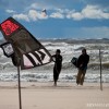 a kiter walking up the beach on lake michigan