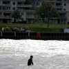 A surfer waits for waves in lake michigan