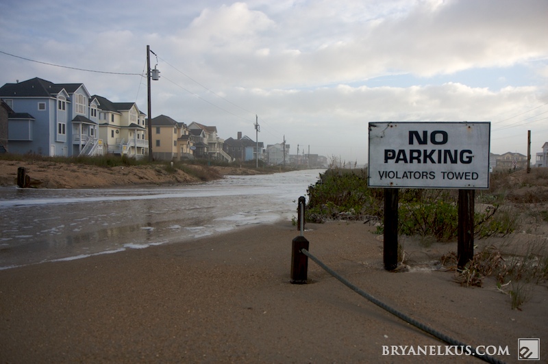 Water and sand run where once a street ran.