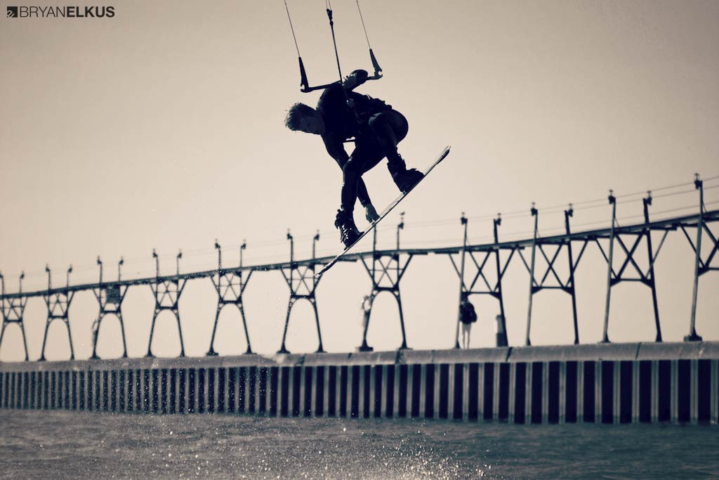 Brandon Schied grabs his kiteboard while kiteboarding in grand haven michigan