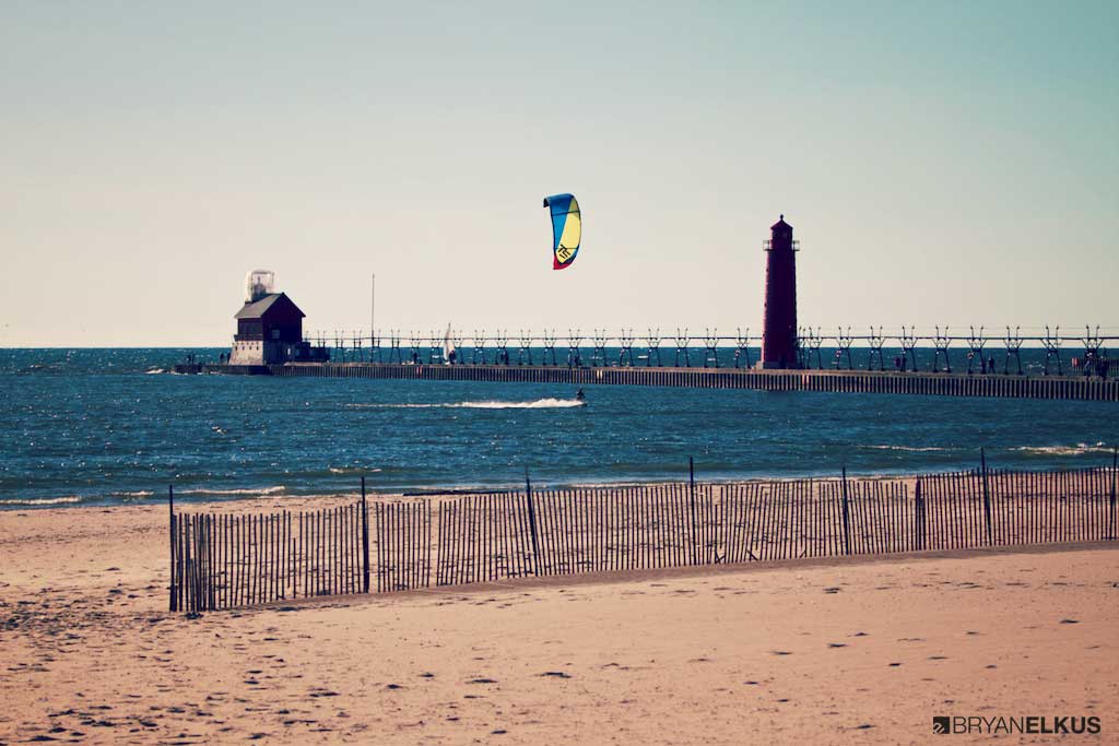 Kiteboarder riding near the grand haven lighthouse in Michigan