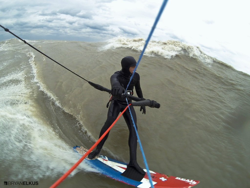 A kiteboarder rides a wave on lake erie near Erieau canada